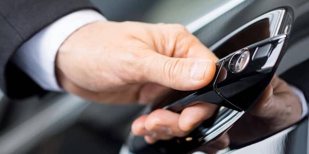 Detail of a person opening a car door